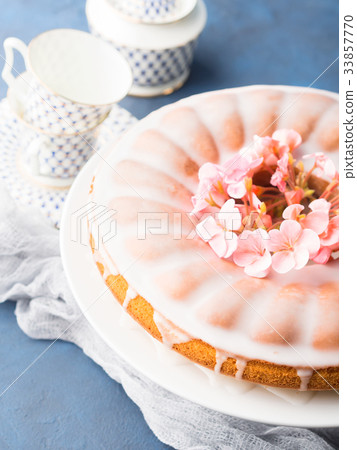 Bundt cake with frosting. Festive treat flowers Bundt cake with frosting. Festive treat flowers 33857770