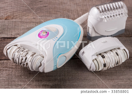 electric epilator hair on an old wooden background 33858801