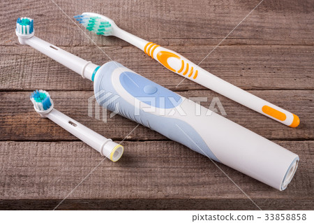 electric and manual toothbrushes on the wooden electric and manual toothbrushes on the wooden 33858858