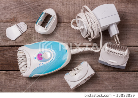 electric epilator hair on an old wooden background 33858859
