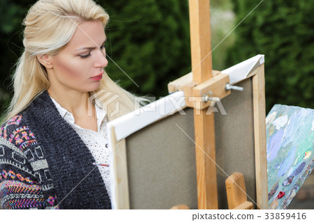 woman artist with a brush in her hand draws on woman artist with a brush in her hand draws on 33859416
