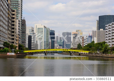 Shadow of yellow bridge and skyscrapers reflected in Tennozu canal Shadow of yellow bridge and skyscrapers reflected in Tennozu canal 33860511