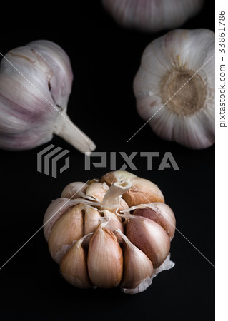 close up of garlic bulb on black background 33861786