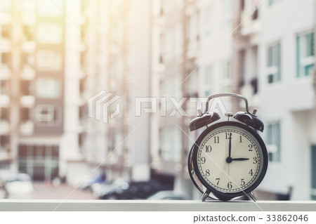 3 o'clock retro clock with condominium background. 33862046