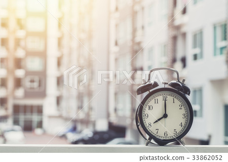 8 o'clock retro clock with condominium background. 8 o'clock retro clock with condominium background. 33862052