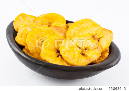 Plantain fried coins in a black clay bowl Plantain fried coins in a black clay bowl 33862643