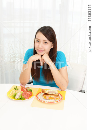 A woman enjoying a meal 33863135