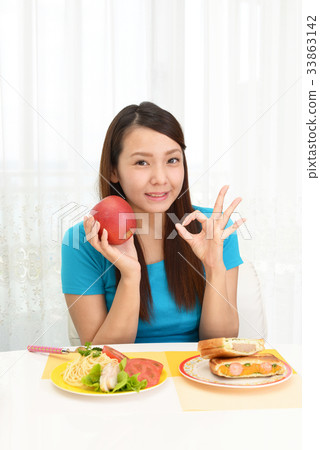 A woman enjoying a meal 33863142