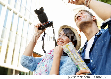 Smiling couple with the camera 33864326
