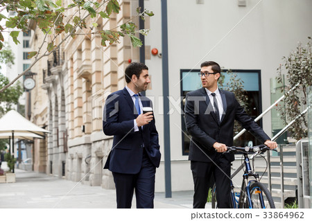 Young businessmen with a bike Young businessmen with a bike 33864962