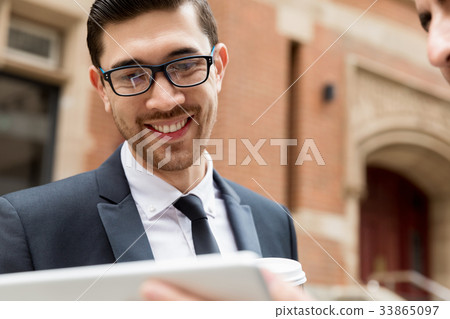 Two businessmen talking outdoors Two businessmen talking outdoors 33865097