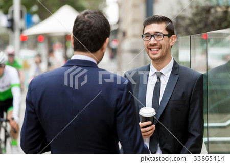 Two businessmen talking outdoors Two businessmen talking outdoors 33865414