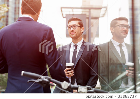 Two businessmen talking outdoors Two businessmen talking outdoors 33865737