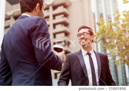 Two businessmen talking outdoors Two businessmen talking outdoors 33865996