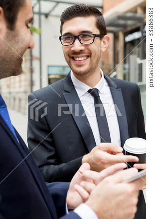 Two businessmen talking outdoors 33866383