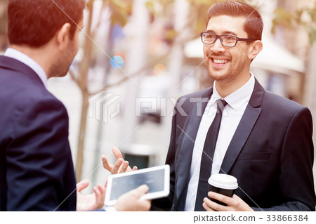 Two businessmen talking outdoors 33866384