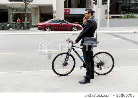 Young businessmen with a bike Young businessmen with a bike 33866795