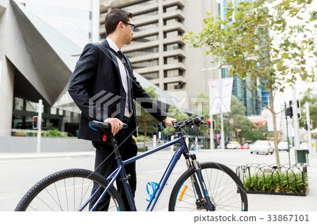 Young businessmen with a bike Young businessmen with a bike 33867101