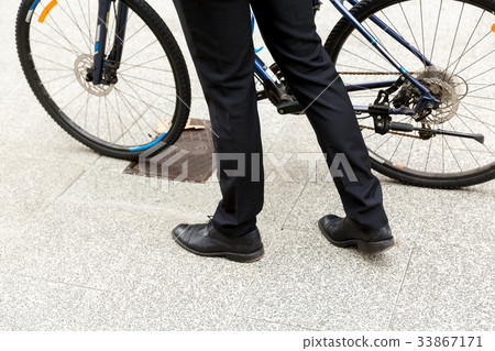 Young businessmen with a bike Young businessmen with a bike 33867171