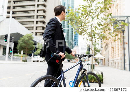 Young businessmen with a bike Young businessmen with a bike 33867172