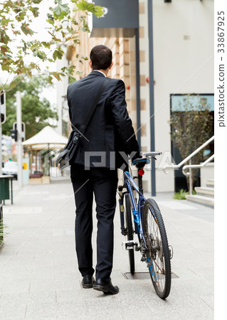 Young businessmen with a bike 33867925