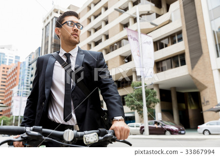 Young businessmen with a bike Young businessmen with a bike 33867994