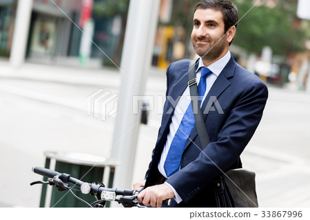 Young businessmen with a bike Young businessmen with a bike 33867996