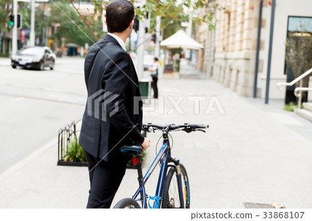 Young businessmen with a bike Young businessmen with a bike 33868107