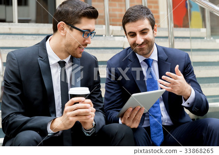 Two businessmen talking outdoors 33868265