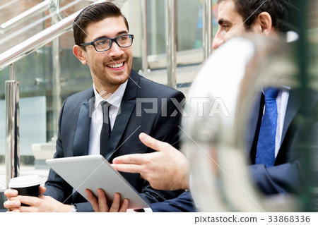 Two businessmen talking outdoors Two businessmen talking outdoors 33868336
