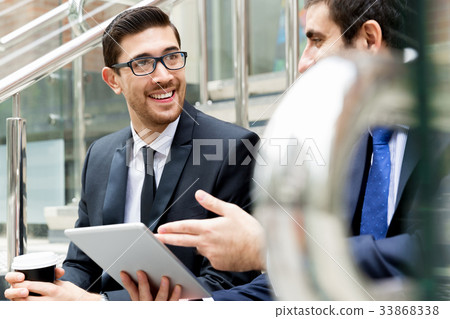 Two businessmen talking outdoors Two businessmen talking outdoors 33868338