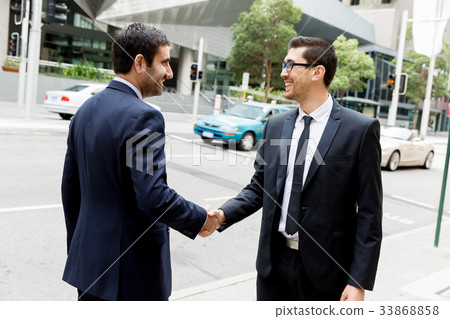 Two businessmen shaking their hands Two businessmen shaking their hands 33868858