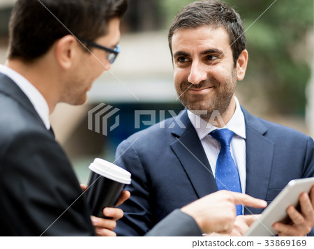 Two businessmen talking outdoors 33869169