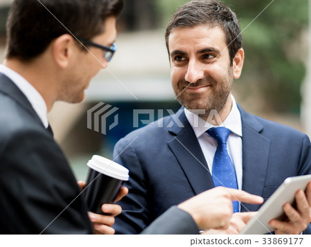 Two businessmen talking outdoors 33869177