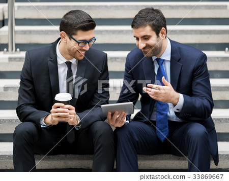 Two businessmen talking outdoors Two businessmen talking outdoors 33869667