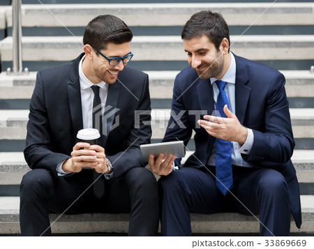 Two businessmen talking outdoors Two businessmen talking outdoors 33869669
