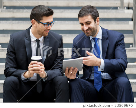 Two businessmen talking outdoors Two businessmen talking outdoors 33869670