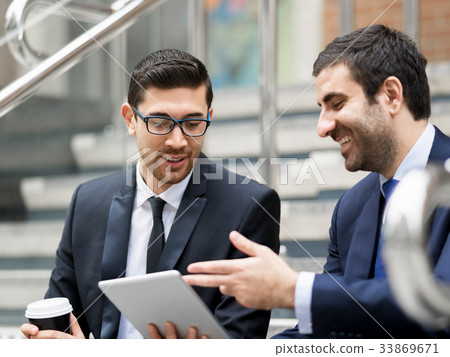 Two businessmen talking outdoors 33869671