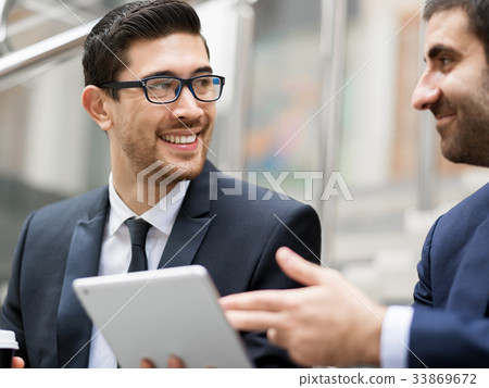 Two businessmen talking outdoors Two businessmen talking outdoors 33869672