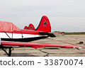 three airplane on the field 33870074