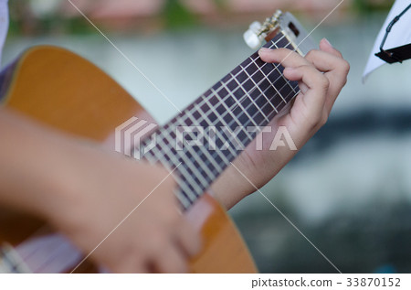 The children play the classic guitar happily. The children play the classic guitar happily. 33870152