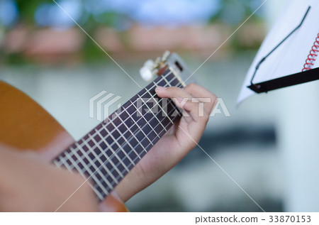 The children play the classic guitar happily. The children play the classic guitar happily. 33870153