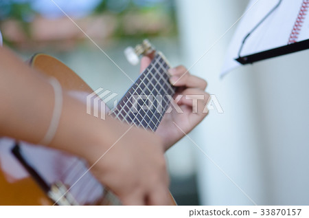 The children play the classic guitar happily. The children play the classic guitar happily. 33870157