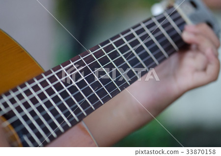 The children play the classic guitar happily. The children play the classic guitar happily. 33870158