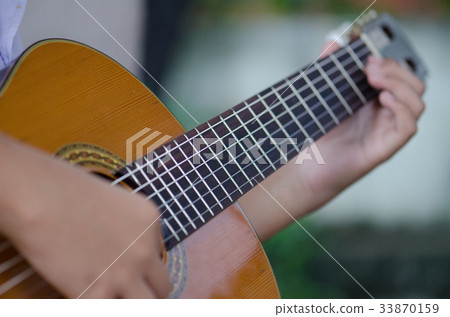 The children play the classic guitar happily. The children play the classic guitar happily. 33870159
