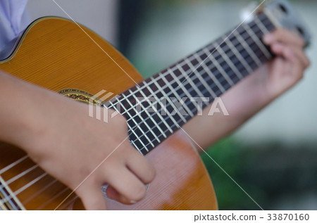 The children play the classic guitar happily. The children play the classic guitar happily. 33870160