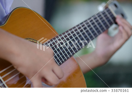 The children play the classic guitar happily. The children play the classic guitar happily. 33870161