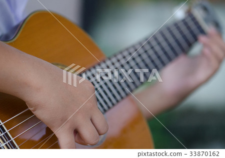 The children play the classic guitar happily. The children play the classic guitar happily. 33870162