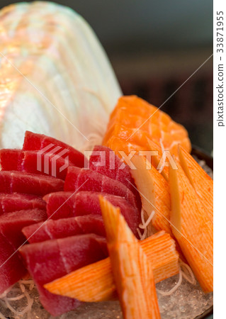 Tuna, sashimi and crab on ice in black cup, 33871955