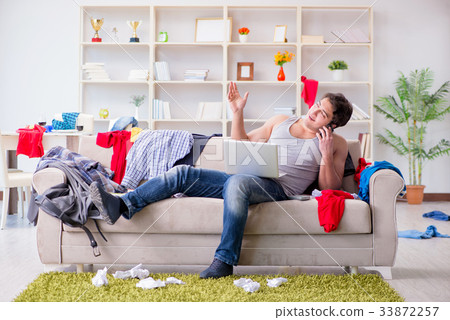 Young man working studying in messy room Young man working studying in messy room 33872257